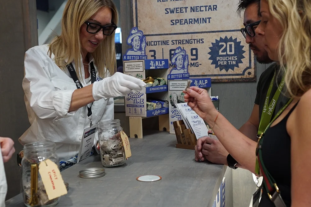 Exhibitor showing samples to people