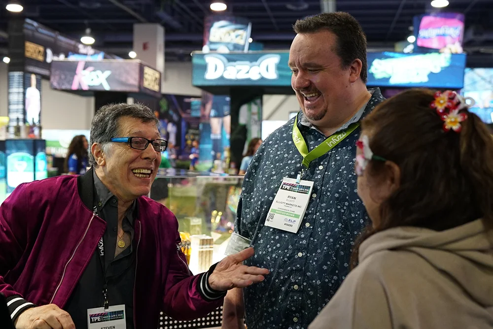 Three people happily talking