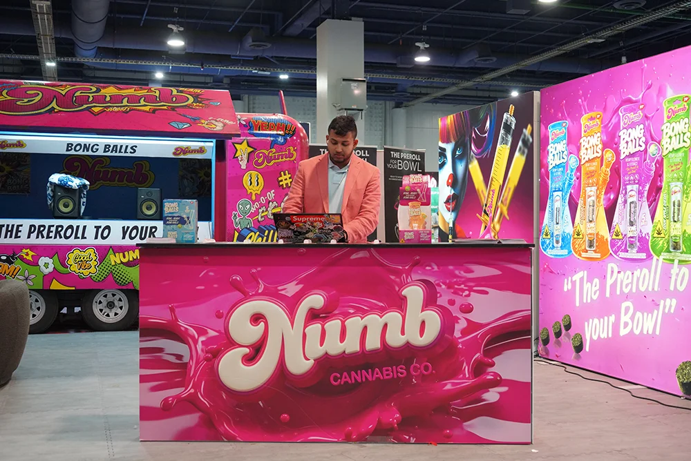 Exhibitor standing behind booth